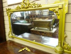 AN OBLONG MIRROR OVERMANTEL having a shaped frame with leaf decoration etc