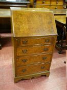 A NEAT 20th CENTURY WALNUT LADY'S BUREAU having a slope front over four opening drawers, 54 cms