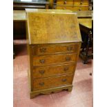 A NEAT 20th CENTURY WALNUT LADY'S BUREAU having a slope front over four opening drawers, 54 cms