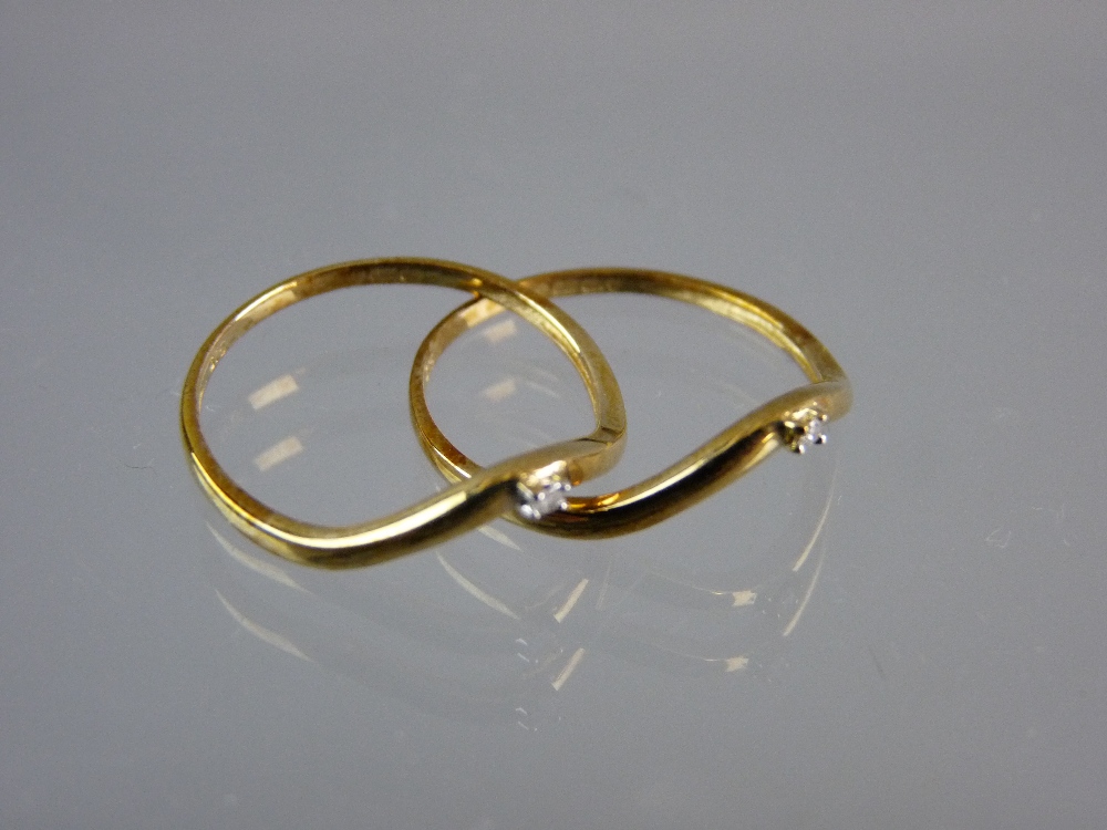 A PAIR OF NINE CARAT GOLD WISHBONE RINGS each with a tiny square cut diamond, 2 grms total