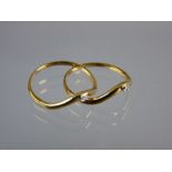 A PAIR OF NINE CARAT GOLD WISHBONE RINGS each with a tiny square cut diamond, 2 grms total