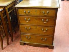 A NEAT ANTIQUE OAK AND MAHOGANY FOUR DRAWER CHEST having a moulded top over four oak lined drawers