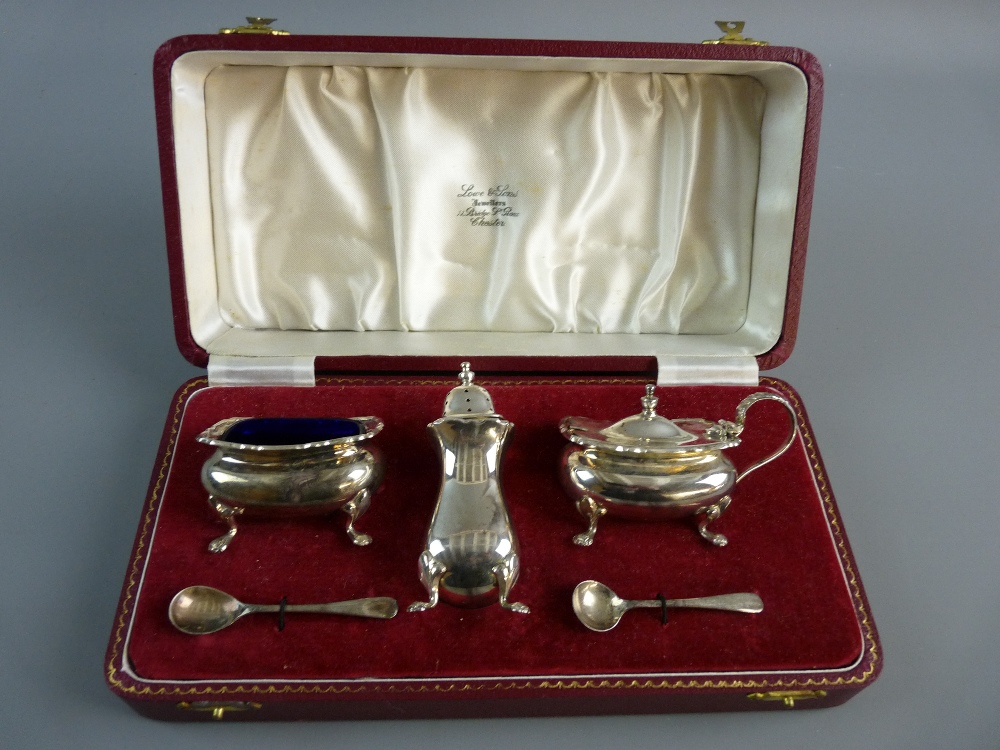A CASED THREE PIECE SILVER CONDIMENT SET to include open salt with blue glass liner, pepper pot