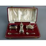 A CASED THREE PIECE SILVER CONDIMENT SET to include open salt with blue glass liner, pepper pot