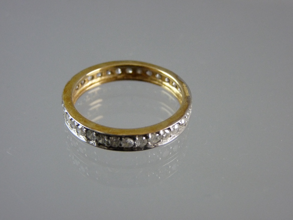 A NINE CARAT GOLD DIAMOND ETERNITY RING with thirty two tiny diamonds plus one missing, 2.3 grms tot