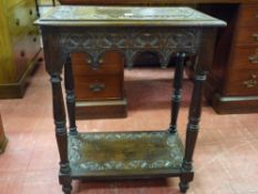 A CARVED OCCASIONAL TABLE, two tier with carved fruit border and carved lunettes to the base