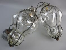 A PAIR OF VENETIAN STYLE HALL LANTERNS, wrought iron frame work and with blown glass, 35 cms