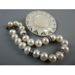 A PEARL BRACELET with four tiny diamond links every four beads and a circular mother of pearl