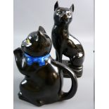 A LATE 19th CENTURY BLACK JACKFIELD POTTERY SEATED CAT on a hollow oval base, 19 cms high (slight