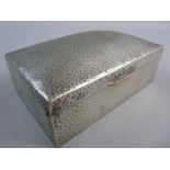 A TUDRIC HAMMERED PEWTER CIGARETTE BOX marked to the base with nos. 01021, 18.5 cms across with