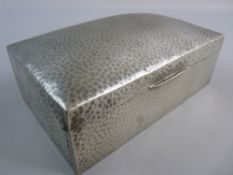 A TUDRIC HAMMERED PEWTER CIGARETTE BOX marked to the base with nos. 01021, 18.5 cms across with