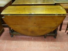 A LARGE ANTIQUE OAK GATE LEG DINING TABLE, oval topped with single end drawer on turned and block