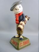 A DUNLOP CADDY GOLFING FIGURE, mounted on a naturalistic square base to inset panels with raised