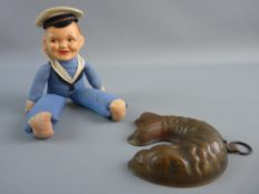 A VINTAGE SAILOR BOY DOLL and copper fish shaped chocolate mould, the composite painted head and