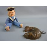 A VINTAGE SAILOR BOY DOLL and copper fish shaped chocolate mould, the composite painted head and