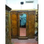 A VICTORIAN MAHOGANY BREAKFRONT TRIPLE WARDROBE, the centre having a full length bevelled mirror and