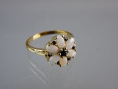 A NINE CARAT GOLD DRESS RING with floral set opals and sapphires, 3 grms total