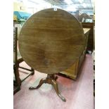 A 19th CENTURY CIRCULAR TOPPED MAHOGANY TRIPOD TABLE having a turned centre pillar to three