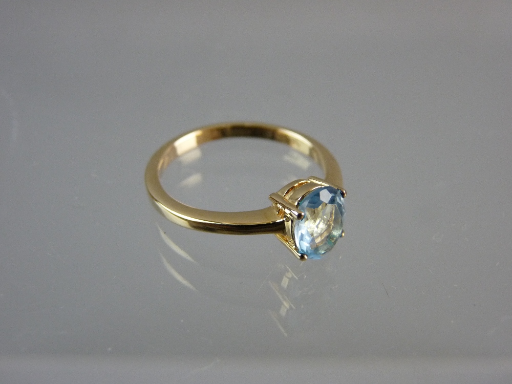 AN UNMARKED GOLD DRESS RING with centre oval aquamarine stone, 2.2 grms total