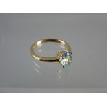 AN UNMARKED GOLD DRESS RING with centre oval aquamarine stone, 2.2 grms total