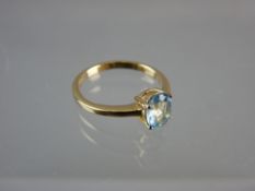 AN UNMARKED GOLD DRESS RING with centre oval aquamarine stone, 2.2 grms total