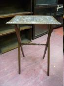 A SMALL OAK FOLDING TABLE with a carved top and turned centre stretcher