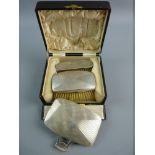 A HALLMARKED SILVER CASED BRUSH AND MIRROR SET to include a stylish finger and thumb held