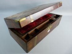 A VICTORIAN ROSEWOOD AND BRASS MOUNTED WRITING SLOPE having a velvet lined interior and spring