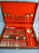 A MID CENTURY OAK CASED CANTEEN OF CUTLERY, red lined interior containing seventy eight pieces of