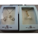 A BOXED PAVE YELLOW METAL NECKLET with pearl drop pendant and a white metal necklet with pearl drops