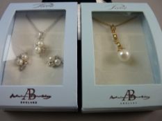 A BOXED PAVE YELLOW METAL NECKLET with pearl drop pendant and a white metal necklet with pearl drops