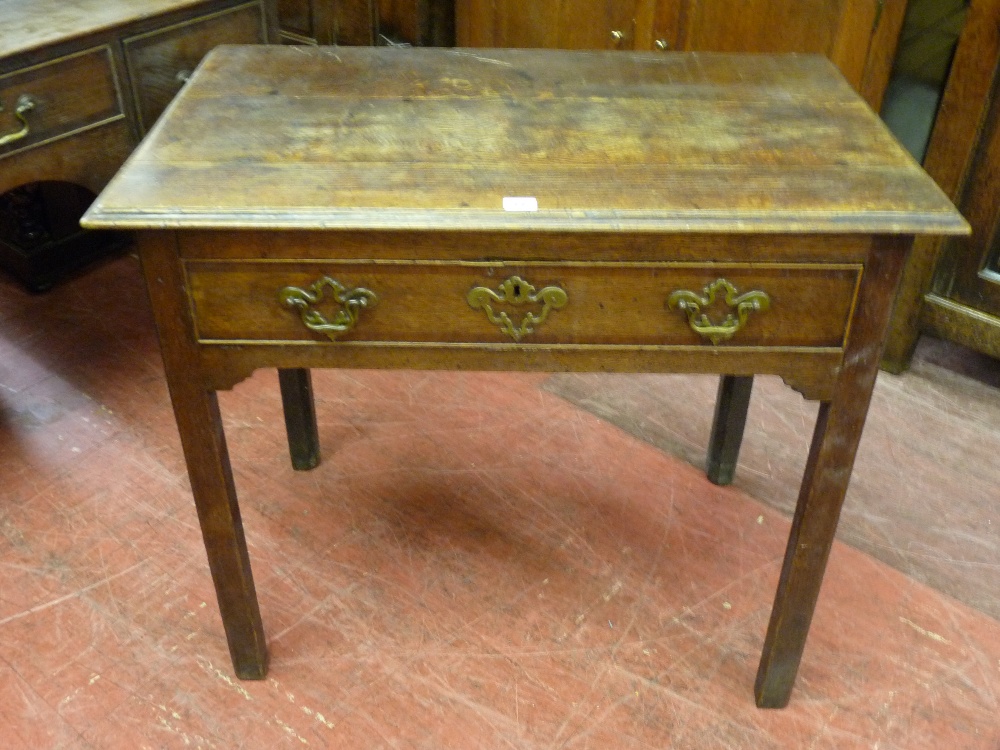 A LATE 18th CENTURY OAK SINGLE DRAWER SIDE TABLE, the three plank moulded edge top over an oak lined