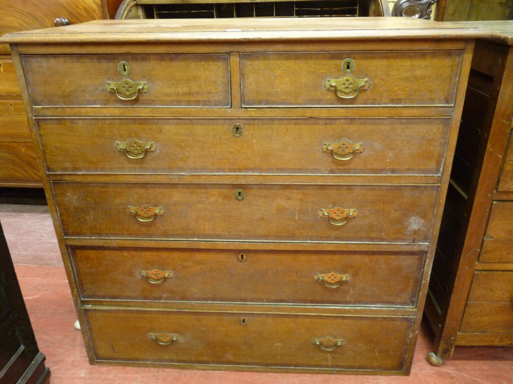 A LATE VICTORIAN OAK AND MAHOGANY CROSSBANDED CHEST having two short over four long drawers with