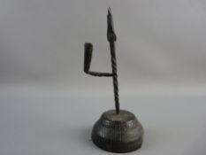 AN 18th CENTURY IRON TALLOW HOLDER of simple form with a straight column on a turned original wooden