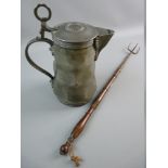 A LIDDED PEWTER FLAGON with hammered facet body and ring thumb piece, angel marked to the base,