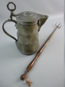 A LIDDED PEWTER FLAGON with hammered facet body and ring thumb piece, angel marked to the base,