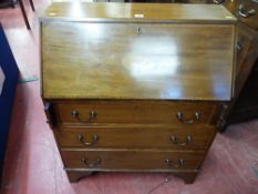 AN EDWARDIAN MAHOGANY AND CROSSBANDED BUREAU the slope front having an oval shell inlay over three