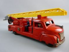 A TINPLATE CLOCKWORK FIRE ENGINE with six seated figures and dinging bell action, 30 cms long,