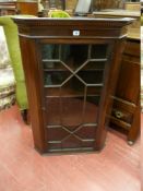 AN ANTIQUE MAHOGANY ASTRAGAL GLAZED DOOR HANGING CORNER CUPBOARD, the thirteen pane door (one