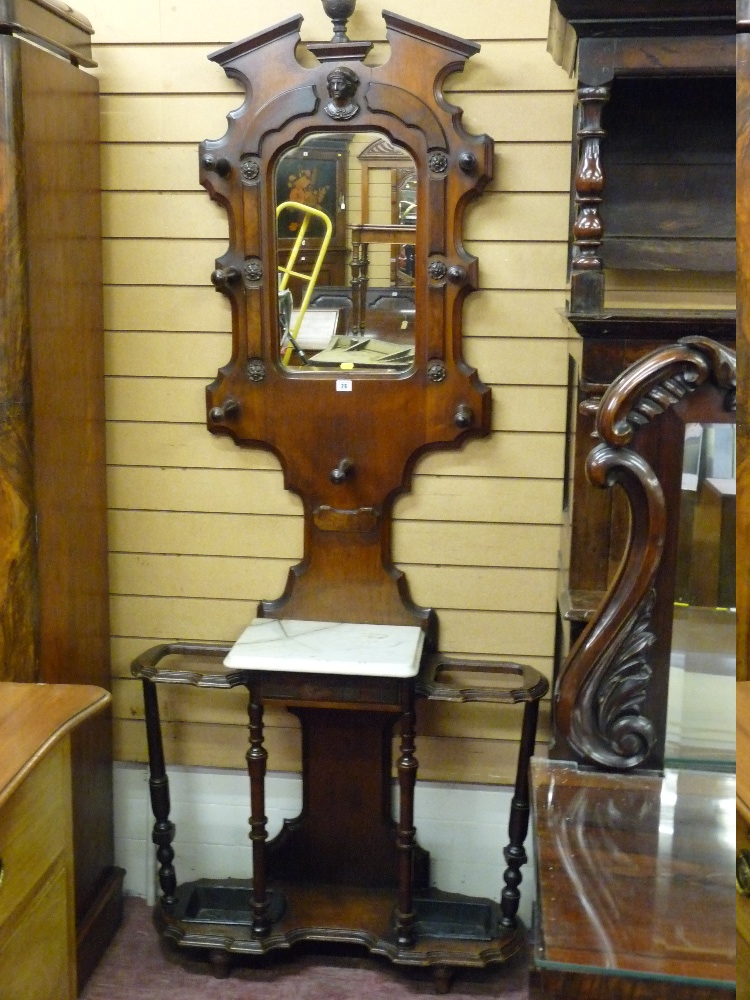 A VICTORIAN MAHOGANY MIRROR BACKED HALLSTAND with white marble centre shelf and cast iron trays (