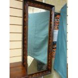 AN ARTS & CRAFTS STYLE FLORAL DECORATED WALL MIRROR, the concave walnut surround leaf and floral