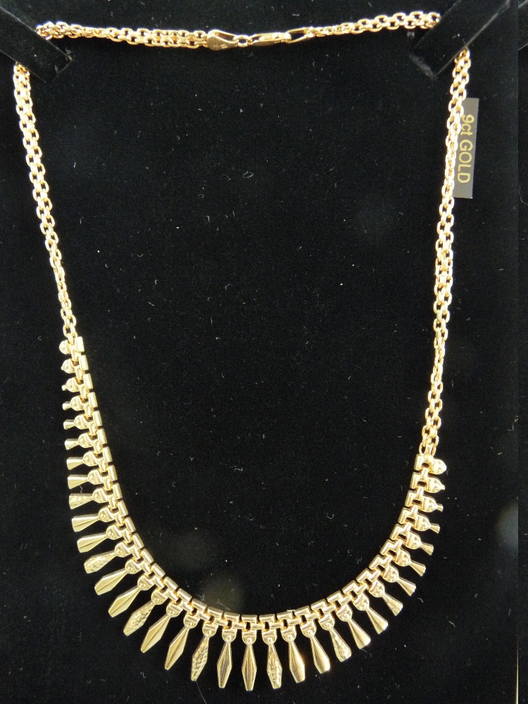 A NINE CARAT GOLD EGYPTIAN STYLE NECKLET of graduated shaped tablets with double link chain, 10.8