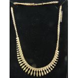 A NINE CARAT GOLD EGYPTIAN STYLE NECKLET of graduated shaped tablets with double link chain, 10.8