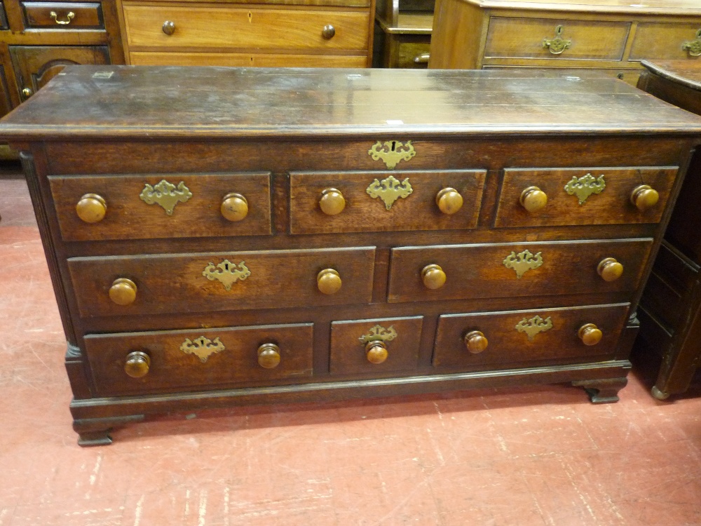 A GEORGE IV OAK AND CROSSBANDED MAHOGANY LANCASHIRE MULE CHEST, the moulded top with shallow