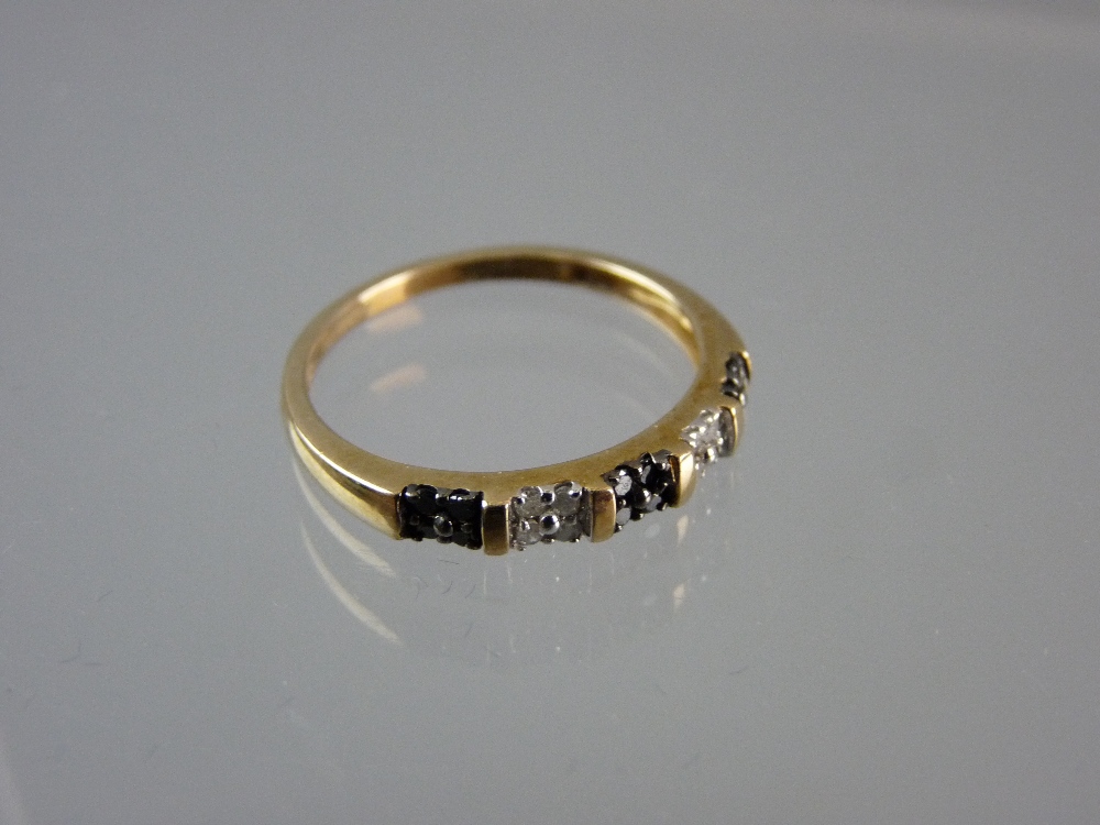 A NINE CARAT GOLD DRESS RING with tiny diamond band, 1.7 grms