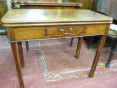A GEORGIAN MAHOGANY OBLONG TOPPED FOLDOVER TEA TABLE with a narrow opening single drawer and