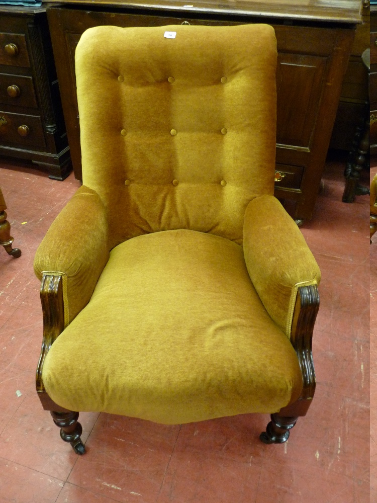 AN EDWARDIAN MAHOGANY ARMCHAIR, a button backed open armchair with turned front supports