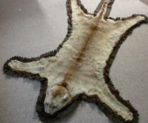 TAXIDERMY, a possibly mountain lion flat skin rug with others, a felt backed head, claws and tail