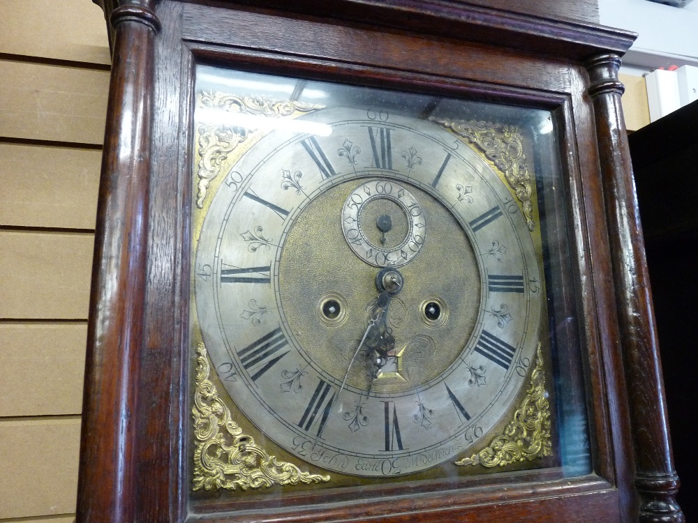 AN 18th CENTURY OAK LONGCASE CLOCK having a wide stepped cornice over a square hood with turned