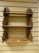 AN OAK THREE SHELF WALL RACK, the graduating shelves with decorative scroll fretwork sides and